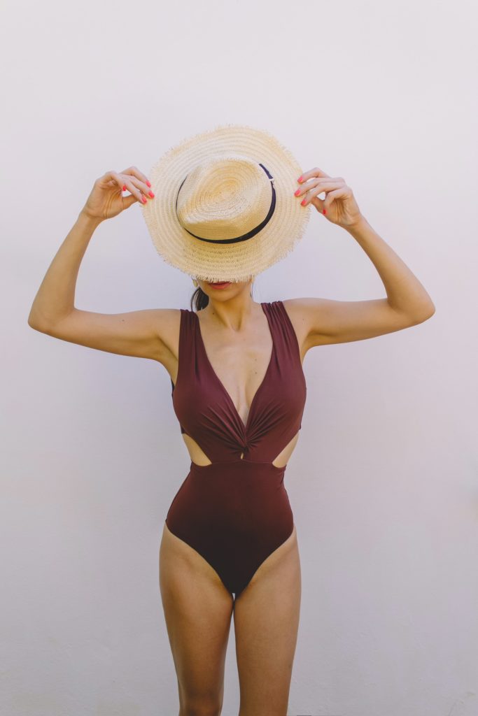 The one-piece can be styled up or down as shown here by a woman wearing it with a hat.